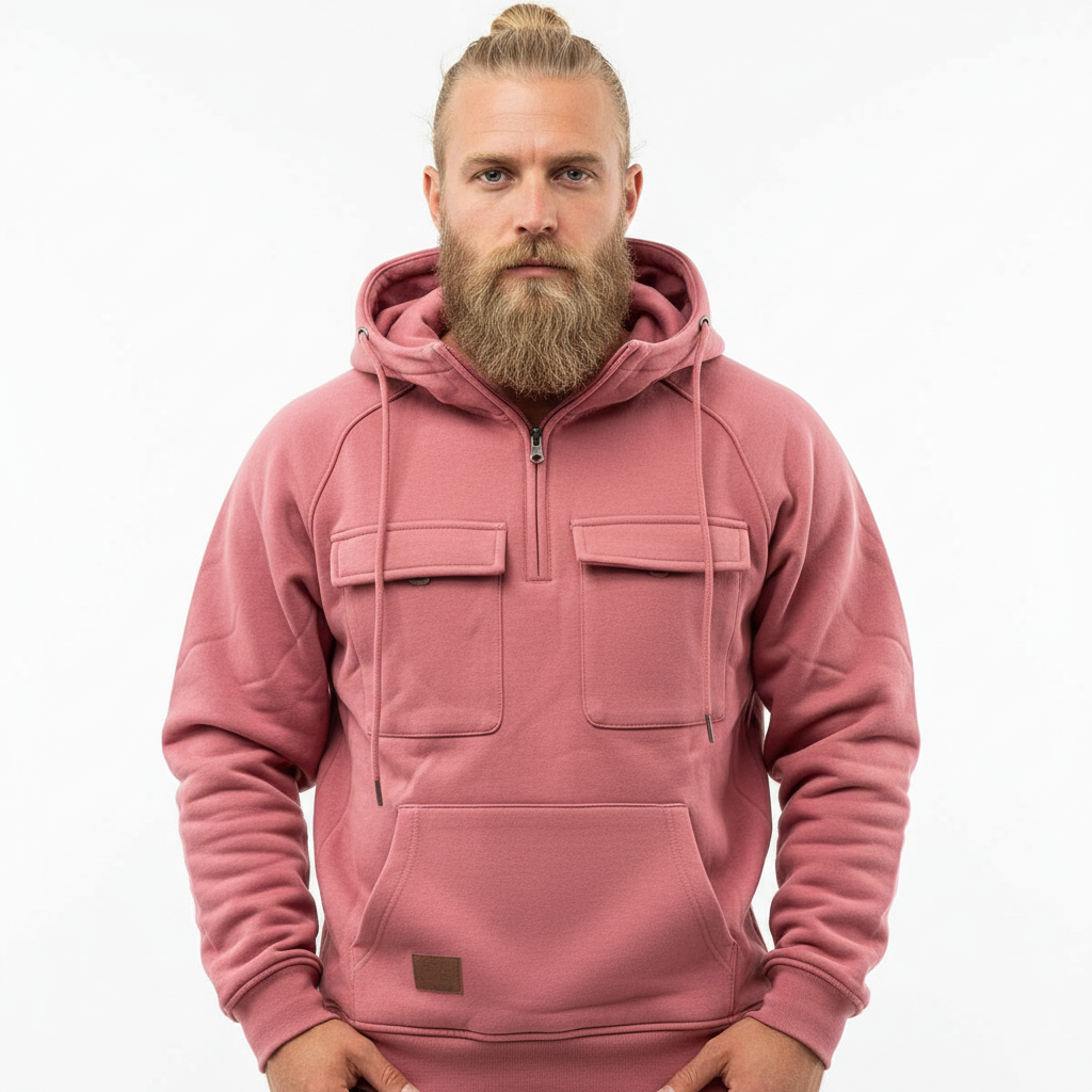 Blond man med manbun i rosa hoodie