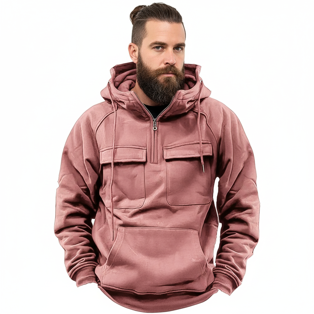 Snygg man med manbun i rosa hoodie